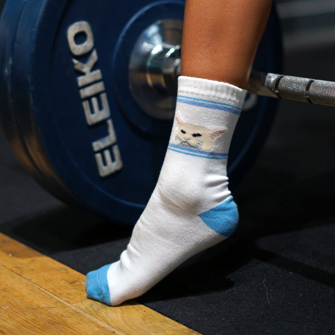 white cat meme socks in the gym