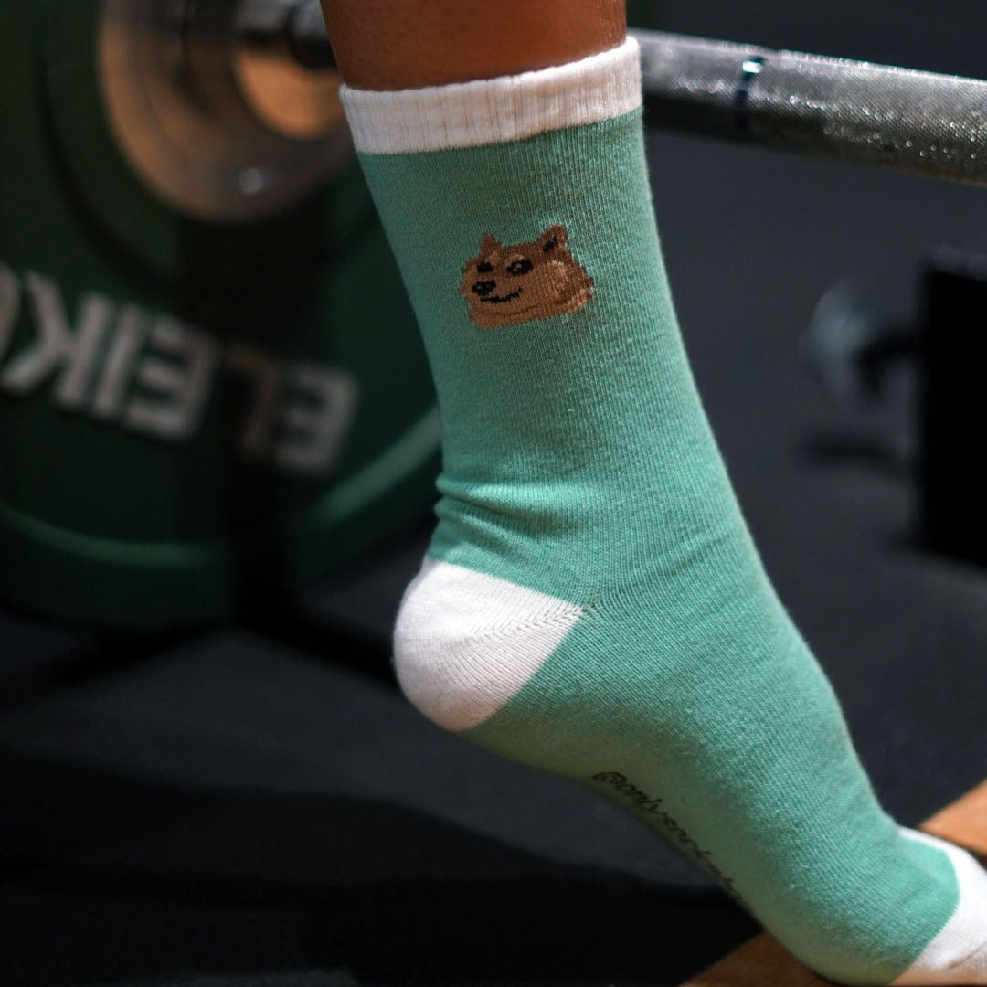 doge socks in pastel green in the gym